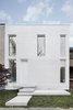 Modern home with Exterior, Brick Siding Material, Green Roof Material, Flat RoofLine, and House. White brick front façade. Reminding several distinctive details of the historical architecture of neighbouring buildings. Photo 2 of The House on Drolet Street