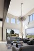 Modern home with Living Room, Coffee Tables, Sofa, Chair, Ceramic Tile Floor, and Pendant Lighting. The layout was rearranged to take advantage of the lake views. Photo 10 of Renton Hill House