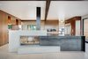Modern home with Living Room, Two-Sided Fireplace, and Ceramic Tile Floor. A custom cast-in-place concrete and blackened steel fireplace. Photo 11 of Renton Hill House