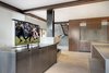 Modern home with Kitchen. The tv emerges from the steel casing for viewing from the kitchen or living room. Photo 13 of Renton Hill House