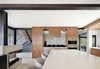 Modern home with Kitchen, Cooktops, Range Hood, Ceramic Tile Floor, Range, Granite Counter, and Wall Oven. Oversized kitchen island for cooking and entertaining. Photo 14 of Renton Hill House