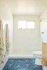 Modern home with Bath Room, One Piece Toilet, Open Shower, Ceramic Tile Floor, Laminate Counter, Ceiling Lighting, and Subway Tile Wall. Bathroom Photo 12 of Midcentury Dream House
