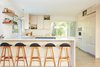 Modern home with Kitchen, Ceramic Tile Backsplashe, Laminate Counter, Wood Cabinet, Light Hardwood Floor, Pendant Lighting, Wall Oven, Refrigerator, Range, and Undermount Sink. Kitchen Photo 9 of Midcentury Dream House