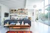 Modern home with Living Room, Pendant Lighting, Sofa, Light Hardwood Floor, Coffee Tables, End Tables, Shelves, Chair, Rug Floor, and Console Tables. Family Room Photo 8 of Midcentury Dream House