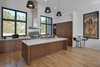 Modern home with Kitchen, Pendant Lighting, Range Hood, Undermount Sink, Engineered Quartz Counter, Light Hardwood Floor, Range, Ceiling Lighting, and Wood Cabinet. Kitchen Photo 5 of House 16
