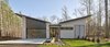 Modern home with Exterior, House Building Type, Flat RoofLine, Mid-Century Building Type, Shed RoofLine, Butterfly RoofLine, Wood Siding Material, and Shingles Roof Material. Exterior Front Photo of House 23