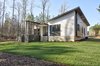 Modern home with Exterior, Flat RoofLine, Mid-Century Building Type, Wood Siding Material, Shed RoofLine, Shingles Roof Material, House Building Type, and Butterfly RoofLine. Exterior Rear Photo 3 of House 23
