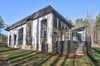 Modern home with Exterior, Shed RoofLine, Flat RoofLine, Shingles Roof Material, Butterfly RoofLine, Wood Siding Material, Mid-Century Building Type, and House Building Type. Exterior Rear Photo 4 of House 23