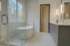Modern home with Bath Room, Wall Lighting, Undermount Sink, Corner Shower, Freestanding Tub, Recessed Lighting, Porcelain Tile Wall, Porcelain Tile Floor, One Piece Toilet, and Engineered Quartz Counter. Master Bath Photo 9 of House 23