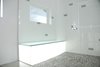 Modern home with Bath Room, Wall Lighting, Enclosed Shower, Freestanding Tub, Floor Lighting, Corner Shower, Metal Counter, Glass Tile Wall, Two Piece Toilet, Subway Tile Wall, Accent Lighting, Full Shower, and Vessel Sink. show bench that glows with the sunlight and diminishes as the sun traverses westward. Photo 11 of Summers