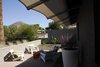 Modern home with Exterior, Brick Siding Material, Concrete Siding Material, House Building Type, Shingles Roof Material, and Hipped RoofLine. Fabric 'eye brow' to the front yard blocks low summer sun. Photo 5 of Summers