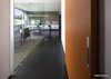 Modern home with Ceiling Lighting, Pendant Lighting, and Concrete Floor. Dining room seen from hallway. Pantry to the right with orange barn door. Photo 18 of Essence of the Desert