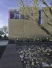 Modern home with Exterior, Concrete Siding Material, Metal Siding Material, Brick Siding Material, Flat RoofLine, and House Building Type. Inspired by the color of Strawberry Hedgehog cactus thriving in the front yard of the house, the window wants to be an abstract flower drawing guests toward the front entrance. The wall lights are abstract luminarias of the southwest landscape. Photo 2 of Essence of the Desert