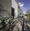 Modern home with Exterior, House Building Type, Flat RoofLine, Concrete Siding Material, and Brick Siding Material. Fabric scrim is beveled slightly inward as gesture to invite guests in to the entry court behind. Photo 20 of Essence of the Desert