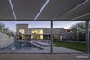 Modern home with Outdoor, Lap Pools, Tubs, Shower, Grass, Concrete Pools, Tubs, Shower, Large Pools, Tubs, Shower, Swimming Pools, Tubs, Shower, Landscape Lighting, Gardens, Back Yard, Concrete Fences, Wall, and Trees. from Pavilion. Backyard overview Photo 11 of Essence of the Desert