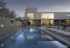 Modern home with Outdoor, Large Patio, Porch, Deck, Hardscapes, Swimming Pools, Tubs, Shower, Concrete Fences, Wall, Back Yard, Trees, Grass, Landscape Lighting, Metal Patio, Porch, Deck, Large Pools, Tubs, Shower, and Concrete Patio, Porch, Deck. from Pavilion looking at the master suite, family room and lofted kitchen Photo 7 of Essence of the Desert