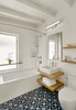 Modern home with Bath Room, Wall Lighting, Concrete Floor, Undermount Tub, Open Shower, Ceramic Tile Floor, Two Piece Toilet, Vessel Sink, Wood Counter, and Subway Tile Wall. A crisp, modern palette complements the mid-century exterior and extends into the bright and airy bathroom, where decorative cement floor tiles serve as the focal point. Photo 6 of Tamalpais Street Residence