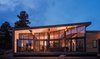 Modern home with Exterior, Metal Roof Material, Glass Siding Material, House Building Type, Metal Siding Material, Shed RoofLine, and Wood Siding Material. Hard shell, soft core. The industrial exterior shell wraps up and over the warm interior of the great room. Photo 3 of Estes Park Residence