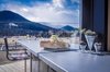 Modern home with Kitchen, Metal Cabinet, Range, Refrigerator, Cooktops, Wall Oven, Microwave, Concrete Floor, Concrete Counter, Concrete Backsplashe, and Wood Cabinet. The kitchen countertop extends onto the deck to form a bar with a view of the Rockies. Photo 7 of Estes Park Residence