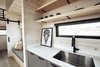 The kitchen and living areas are integrated together inside the large main room, yet each can still function as its own autonomous zone.
Photo 14 of Land Ark RV - Drake modern home