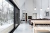 Modern home with Living Room, Concrete Floor, Pendant Lighting, and Wood Burning Fireplace. Throughout the design, the site was quickly revealed as a powerful element of the project. By choosing carefully the location and size of each window, external views were highlighted, and the atmosphere created by natural light is pleasant throughout the whole day. As for the position of the large sliding door, it was “ pushed “ toward the main interior open space with the intention of subtly separating the internal functions while creating a outside protected space. All these intentions ultimately aim to capture the essence of this project: the surrounding nature and wildlife. Photo 3 of Villa Boréale