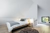 Modern home with Bedroom, Bed, Chair, Light Hardwood Floor, and Wall Lighting. The master bedroom with king bed is located on the spacious open mezzanine and offers a cozy reading place. Photo 10 of Villa Boréale