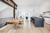 Modern home with Dining Room, Slate Floor, Stools, Recessed Lighting, Light Hardwood Floor, Table, Pendant Lighting, and Chair. 12' ceilings with original brick, wood floor joists and new structural steel Photo 2 of The Susan Elkins House