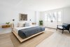 Modern home with Bedroom, Night Stands, Wall Lighting, Bed, Light Hardwood Floor, and Chair. lower level master bedroom walks out into yard, created with 12' of excavation Photo 3 of The Susan Elkins House