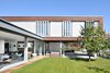 Modern home with Exterior, Concrete Siding Material, Stucco Siding Material, Glass Siding Material, Wood Siding Material, Flat RoofLine, and House Building Type. Courtyard Photo 6 of House KI