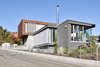 Modern home with Exterior, Flat RoofLine, Wood Siding Material, Concrete Siding Material, House Building Type, Stucco Siding Material, Glass Siding Material, and Metal Siding Material. Exterior view. Photo 8 of House KI
