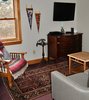 Modern home with Living Room, Sofa, Coffee Tables, Rug Floor, Wall Lighting, Carpet Floor, and Chair. The tiny den in the rear of the house. Photo 5 of Featherbed Island House. Bayfront Vacation Rental