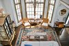 Modern home with Living Room, Ceiling Lighting, Table Lighting, Dark Hardwood Floor, Accent Lighting, Chair, Wood Burning Fireplace, Coffee Tables, and Sofa. The great room taken from the loft Photo of Featherbed Island House. Bayfront Vacation Rental