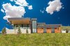 Modern home with Exterior. Designed to leave no view unnoticed, this two-story window brings in natural light and showcases the custom-made, metal staircase. Photo 3 of Purple Sage