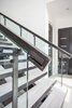 Pairing glass and metal to create a showpiece staircase. Photo 15 of Purple Sage modern home
