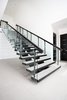 A stunning, metal staircase is the most prominent of the two staircases in the home. Photo 14 of Purple Sage modern home