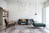 Modern home with Living Room, Medium Hardwood Floor, Sofa, Floor Lighting, Bookcase, Coffee Tables, Ottomans, Pendant Lighting, and Rug Floor. The open-concept living space is filled with natural light. Photo 2 of Interior KG