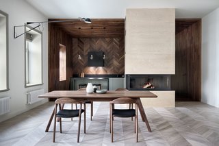 Light and dark herringbone parquetry combine to create a dynamic dining area.