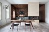 Modern home with Dining Room, Light Hardwood Floor, Table, Chair, Wall Lighting, Stools, Bar, and Gas Burning Fireplace. Light and dark herringbone parquetry combine to create a dynamic dining area. Photo of Interior KG