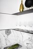 Modern home with Kitchen, Marble Backsplashe, Beverage Center, Cooktops, Light Hardwood Floor, Drop In Sink, Metal Cabinet, and Marble Counter. The home bar in the condo's kitchen features Carrara marble with metal shelving for a modern look. Photo 7 of Seaholm Custom Condo