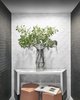 Modern home with Hallway, Brick Floor, Ceramic Tile Floor, and Light Hardwood Floor. Seaholm Powder Room sitting area in modern downtown Austin condo. Designed with black brick and scalloped tile walls. Featuring a vase with olive branches for an added touch. Photo 16 of Seaholm Custom Condo