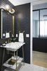 Modern home with Bath Room, Drop In Sink, Ceramic Tile Floor, Stone Tile Wall, and Marble Counter. Modern Seaholm Powder Room in downtown Austin condo. Featuring a Carrara marble vanity with brass hardware, black tile brick walls and scalloped floor tile. Photo 15 of Seaholm Custom Condo