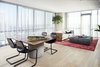 Modern home with Dining Room, Table, Chair, Table Lighting, and Light Hardwood Floor. Modern living room with leather sling chair, walnut frame sofa, and wooden tabletop with a concrete base. Photo 3 of Seaholm Custom Condo