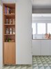 Modern home with Kitchen, Wood Cabinet, White Cabinet, Subway Tile Backsplashe, and Recessed Lighting. You can still infuse open kitchen shelving into your space without foregoing all cabinetry. For instance, base cabinets typically should maintain their doors, as it's easier to get lower shelves dirty and damage any dishware inside. Photo 13 of AML Apartment