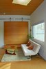 Modern home with Living Room, Coffee Tables, Sofa, Recessed Lighting, Ceiling Lighting, and Cork Floor. Massive sliding bamboo door Photo of Modern Studio - Pet Friendly