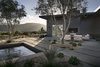 Another perspective of the home's rear exterior including an outdoor fireplace. Photo 3 of Carmel Valley Vistas modern home