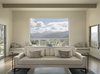Modern home with Living Room, Gas Burning Fireplace, End Tables, Ceiling Lighting, Sofa, Ottomans, and Medium Hardwood Floor. Windows on three sides of the living room take advantage of mountain and valley views. Photo 5 of Carmel Valley Vistas