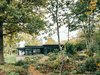 Modern home with Exterior, Wood Siding Material, House Building Type, Cabin Building Type, Flat RoofLine, and Metal Roof Material. forrest view Photo of Villa G