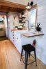 Modern home with Kitchen, Drop In Sink, Refrigerator, Wood Counter, Range, Range Hood, White Cabinet, and Light Hardwood Floor. Tons of storage for a Tiny House. Photo 4 of Not So tiny Tiny, for a Doctor in California