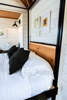 Here, the cedar slab desk is folded up for use as a headboard.