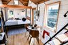 Modern home with Bedroom, Storage, Wall Lighting, Light Hardwood Floor, and Bed. Elevator bed in down position. Photo 2 of Not So tiny Tiny, for a Doctor in California